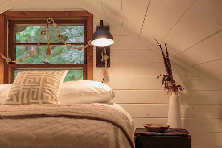 Our loft space offers a full sized bed. Airy and cozy spot for naps.