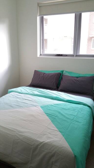 Sun-filled bedroom with comfy bed.