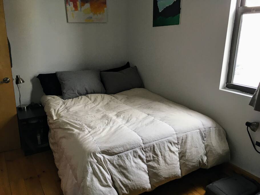 Third bedroom with a large, comfy full bed and a view of Bushwick.