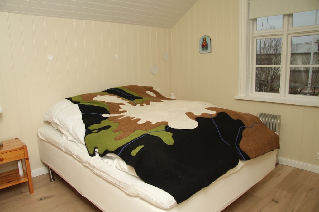 Bedroom with double bed, bedside tables and drawer