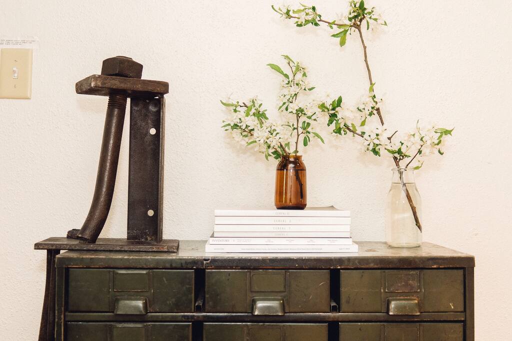 The hallway decor is always changing, but it's typically a mix of salvaged furniture, design periodicals and fresh cut flowers.