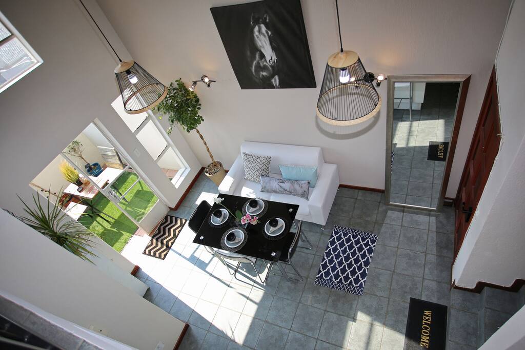 Entrance with open plan kitchen, terrace, and dining