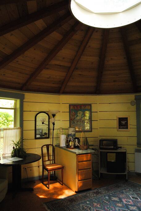 Full kitchenette, dining table, and lovely light from the garden.