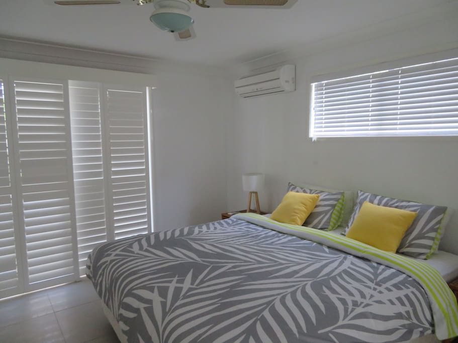 Spacious master bedroom with A/C & WIR and large disabled en-suite - screened doors leading out to the yard.