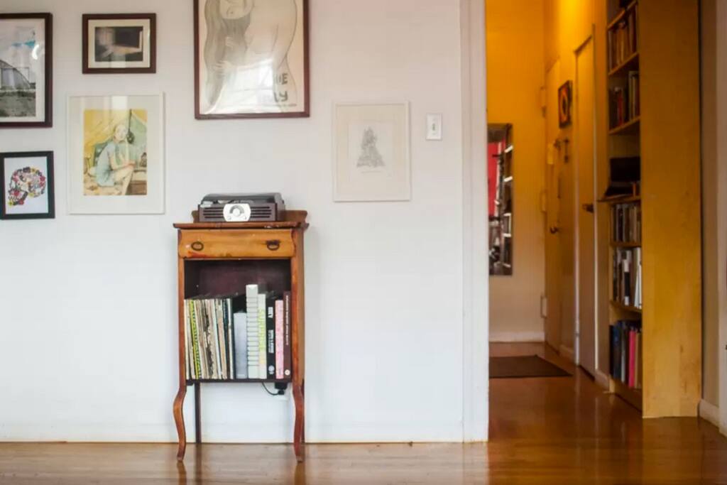 Living room kitchen hallway view, with record player and records.