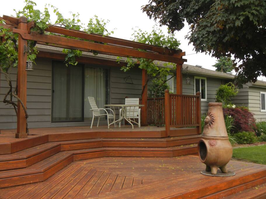 The back patio leads to a large backyard, garden and orchard