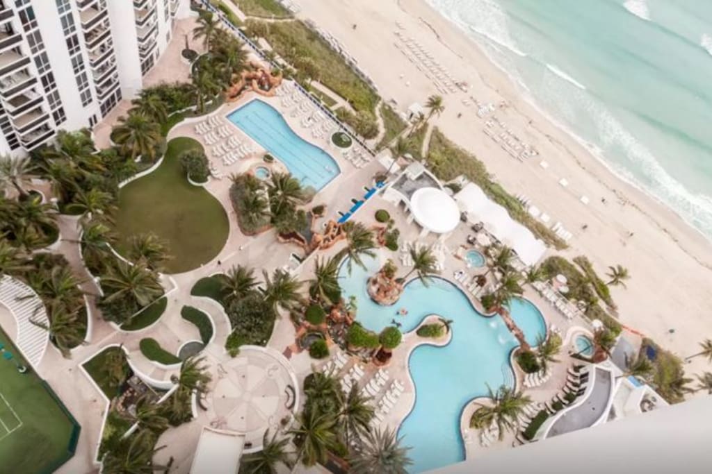 Top view of the resort's beautiful outdoor pools and beach amenities