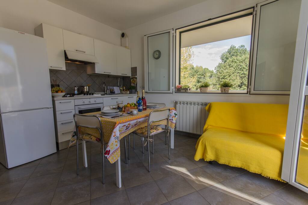 Living area with full kitchen, dining table and TV