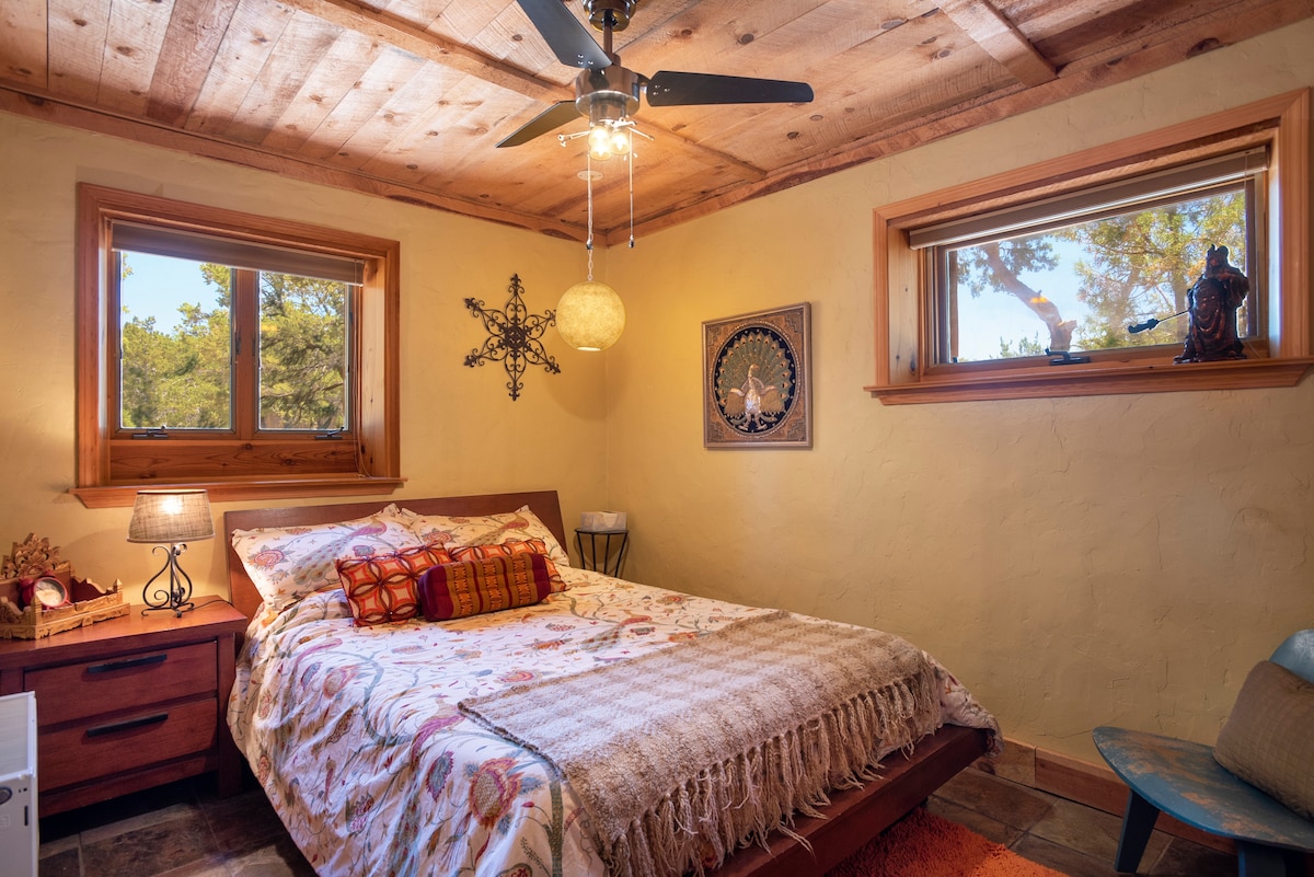 Queensize slaapkamer in verre oostelijke stijl. Vol natuurlijk licht en een prachtig uitzicht op de zuidkant van de accommodatie. 