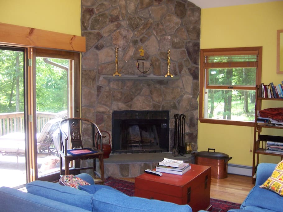 stone fireplace, wood supply near under deck