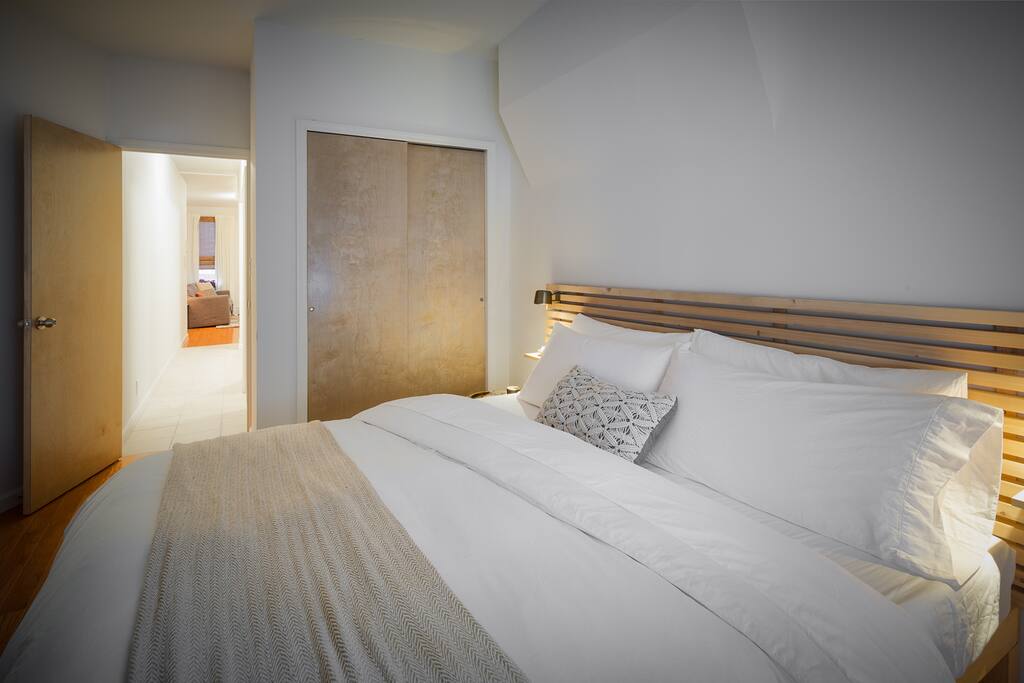 Dimmable bedside reading lamps so one person can read while the other sleeps. Clothing closet for guest use, with iron and ironing board