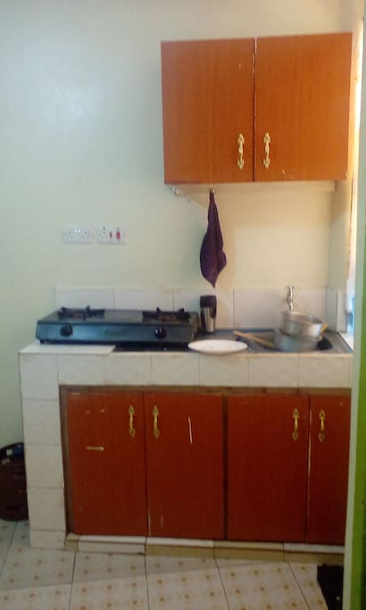 Kitchen fitted with drawers for storage,gas and two cooker burners provided