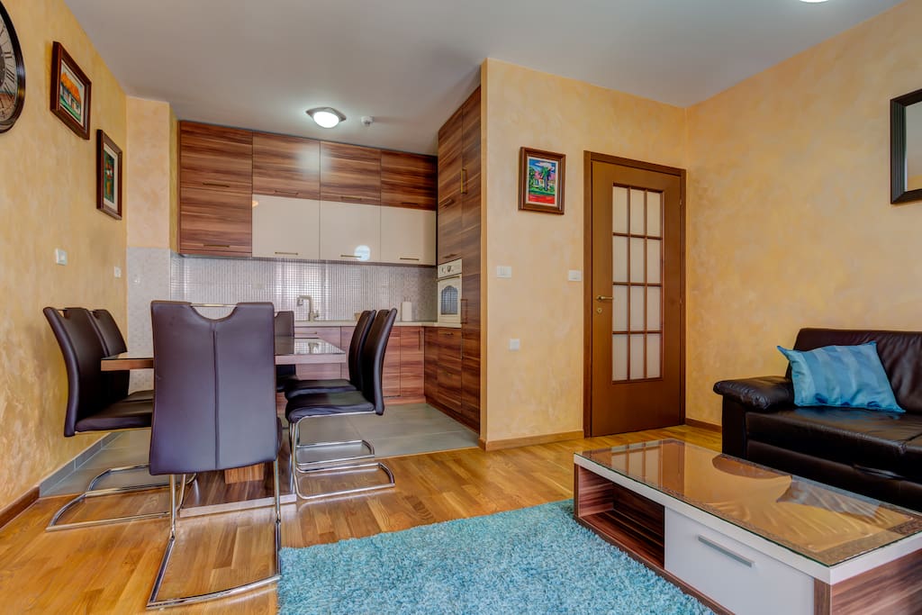 In the living room there is a comfortable leather corner set, table and flat screen TV with cable television.