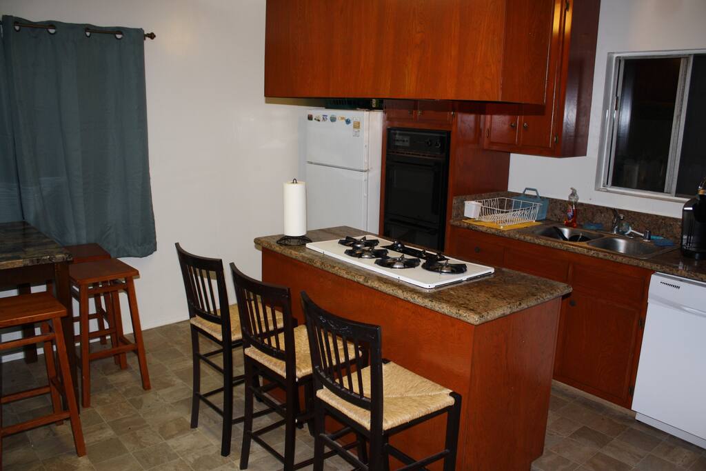 Kitchen with comfortable seating available up to 7. Every necessary amenity for cooking available
