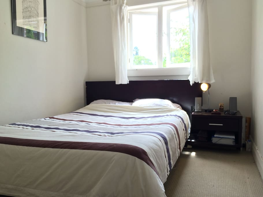 Comfortable Queen-sized bed and side table