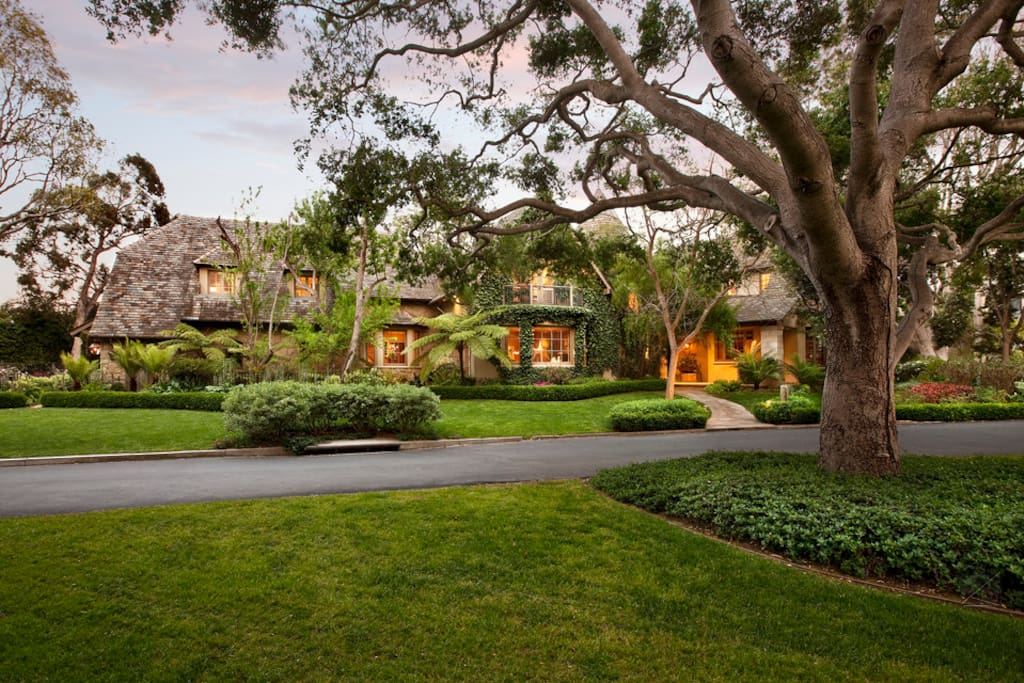 This French Normandy style home is adorned by beautifully landscaped grounds with tropical foliage. It's located in the prestigious gated community of Sea Meadow in Montecito.