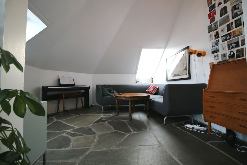 Extra living room with tv, electric piano and heated floor.