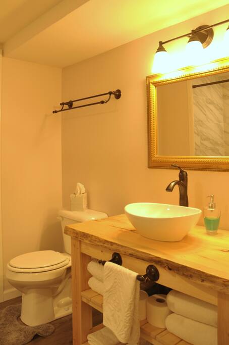 Ashlees's Room bathroom features a new modern vanity and large shower. This bathroom is shared with Traci's Room.