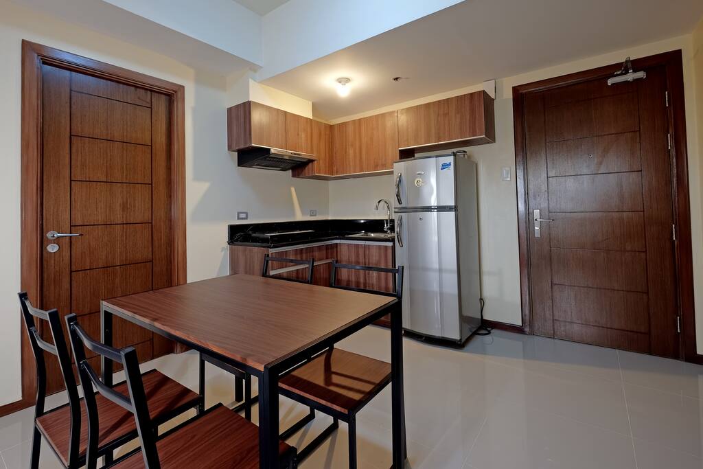 Kitchen has electric stove & fridge