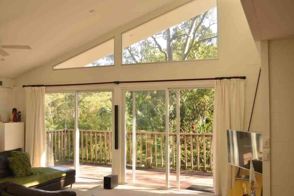 Light-filled lounge with high ceiling and beautiful bush outlook