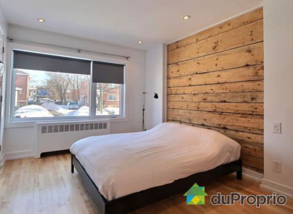 Spacious guestroom with large window and lots of closet space.
