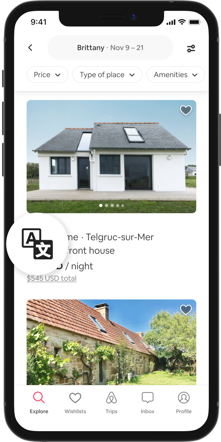 A cell phone shows search results of places to stay in Brittany, France. There is a translation icon that is being magnified in a circle.