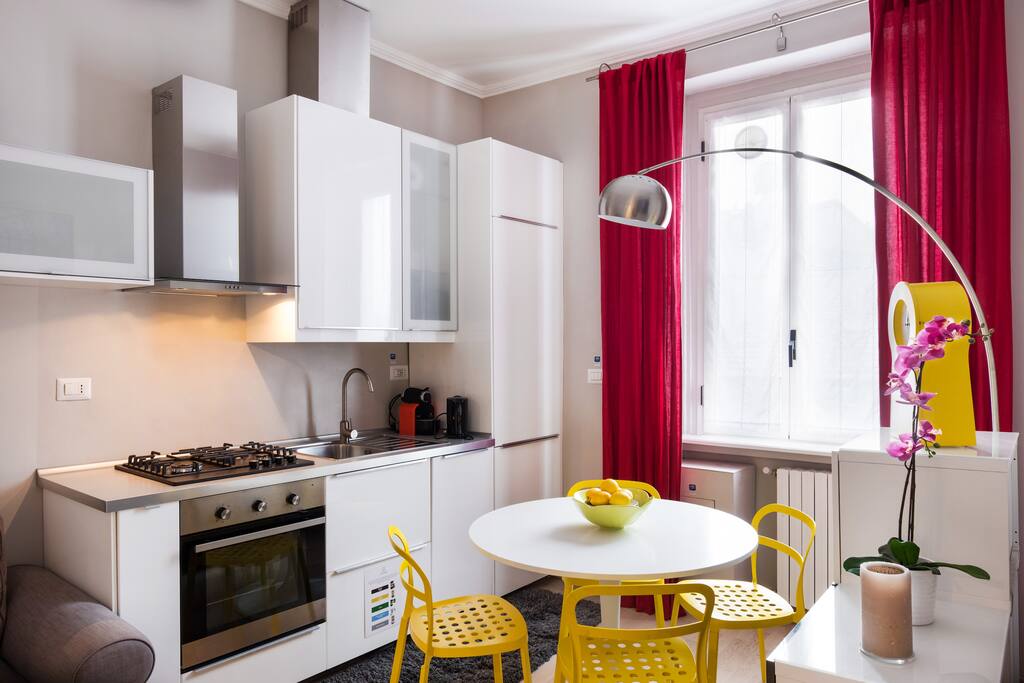 The living room (the equipped kitchen, TV & the dining table)