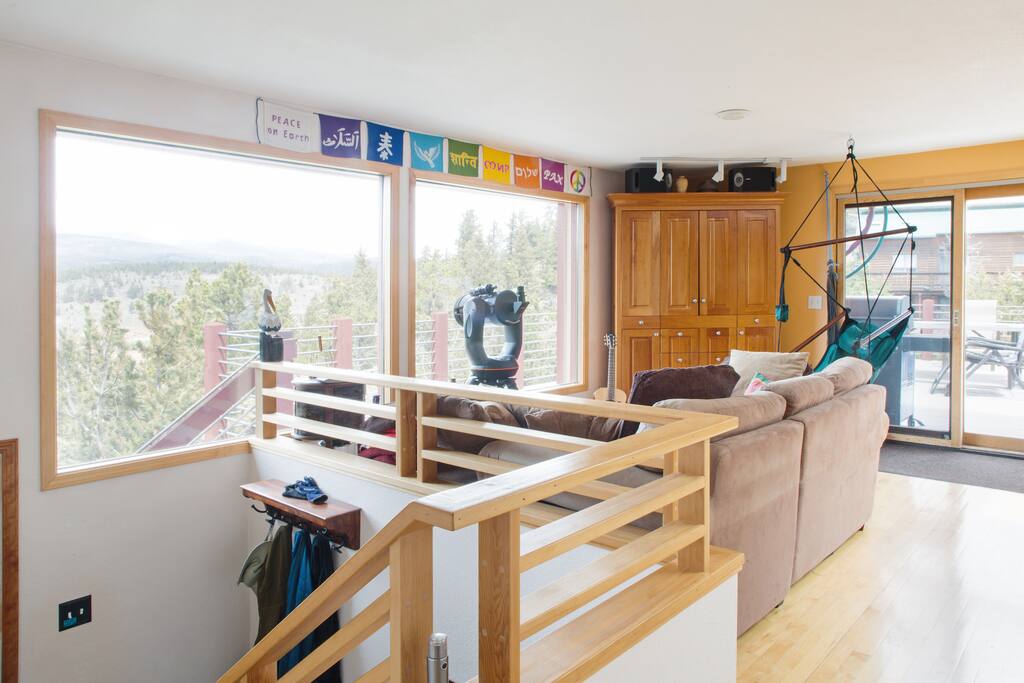upstairs living room, with telescope and hanging chair. (hanging chair can also hang in master bedroom, and downstairs)
