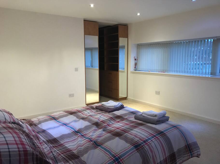 Main bedroom with huge walk in wardrobe and ensuite bathroom with waterfall shower and WC.