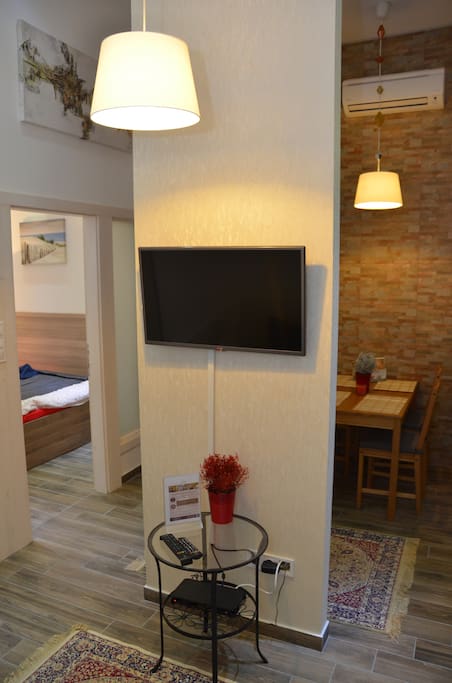 Living room with LCD TV and view to bedroom 2 and