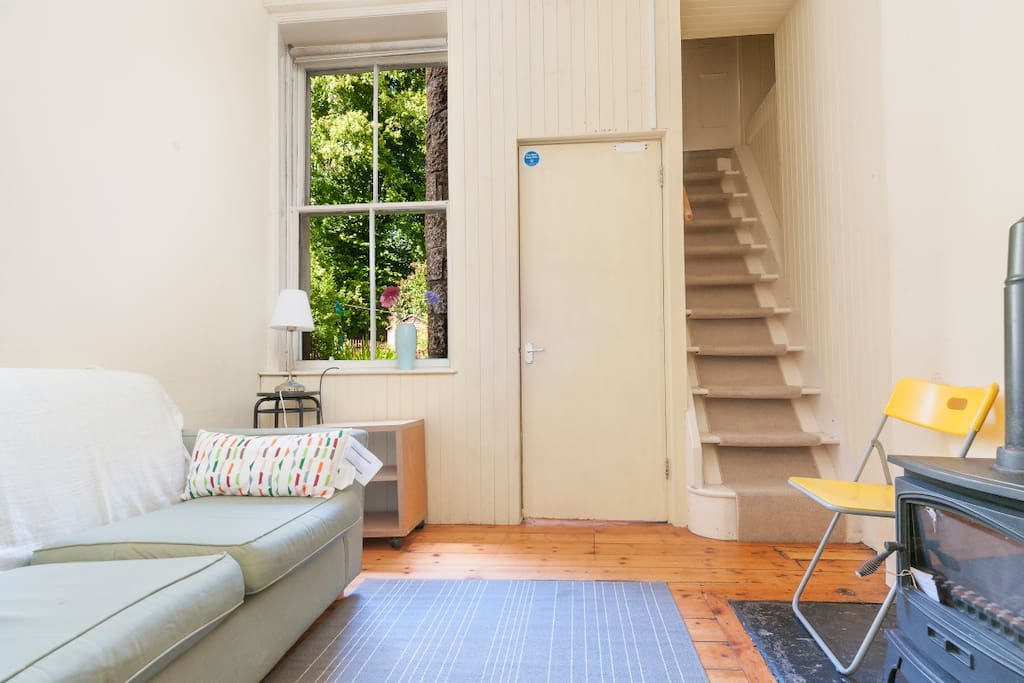 Lounge/diner overlooking rear gardens with stairs to snug