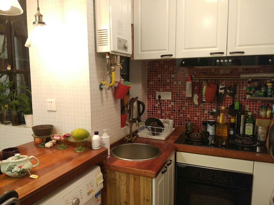 Kitchen with oven, 2 burners, hot water, and a washing machine