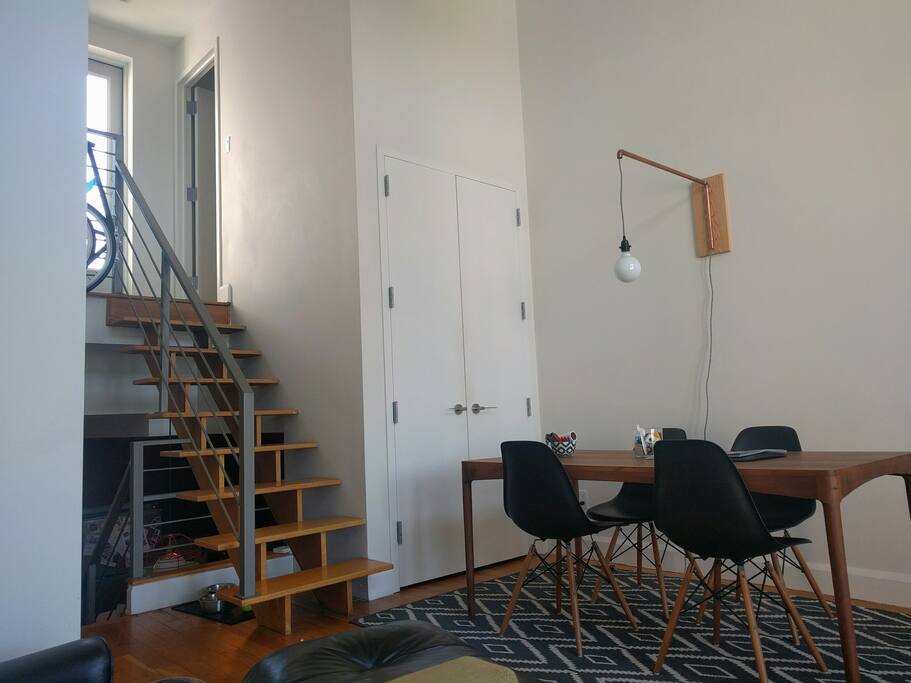 Dining area with stairs leading up to laundry and private roof deck