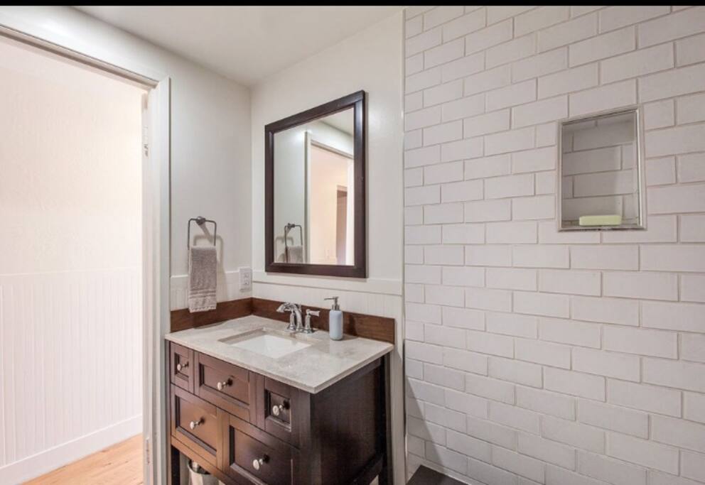 Full bathroom with bathtub & shower.