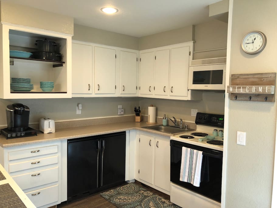 The kitchen features an oven, electric stove, microwave, Keurig, and toaster. The bonus is an under-counter "beer fridge" and freezer.