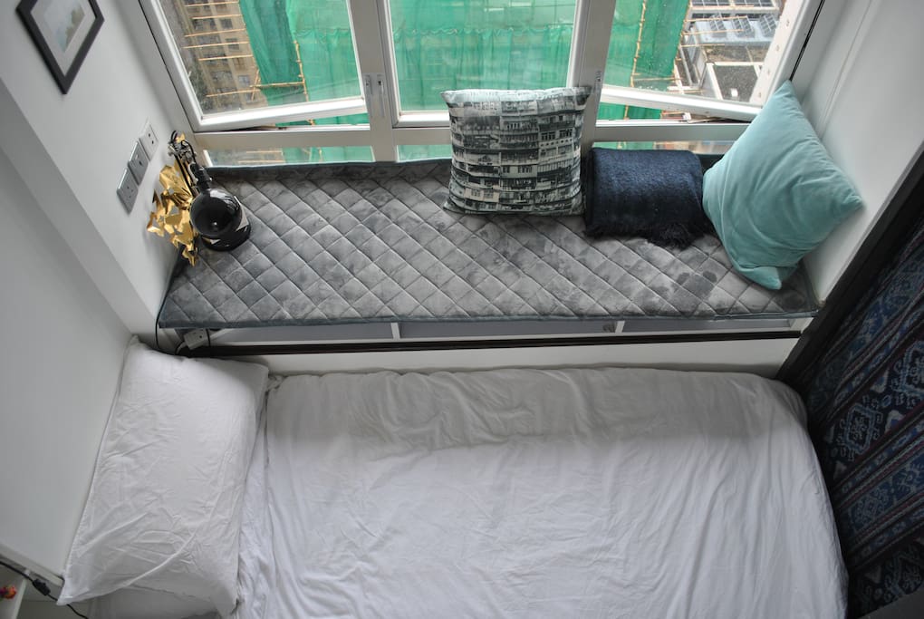 Top-down view of bed and window sill in your bedroom.