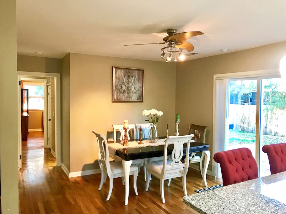 View from the kitchen of the dining room, back patio and hallway leading to guest bath and bedroom #3.