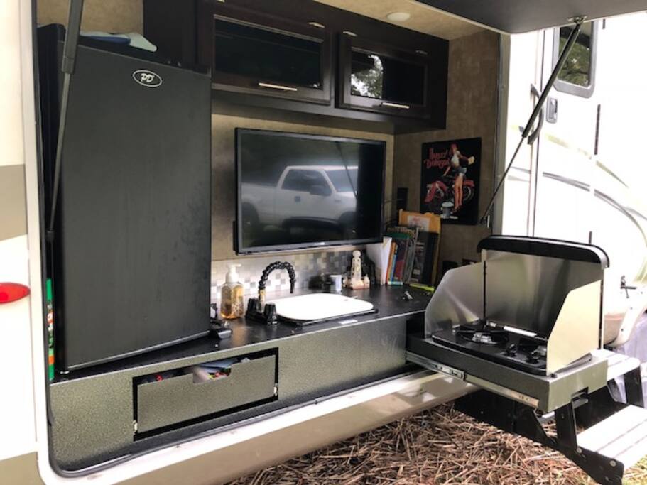 Outside TV, 2 burner stove with sink.