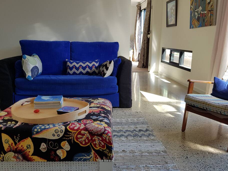 Lounge room with north facing aspect, commercial grade windows to floor with louvres for cross ventilation. Polished concrete floors. Double size sofa bed with mattress topper for extra comfort.