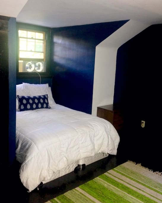 Guest bedroom has 2 rooms. Queen bed, leather chair with ottoman