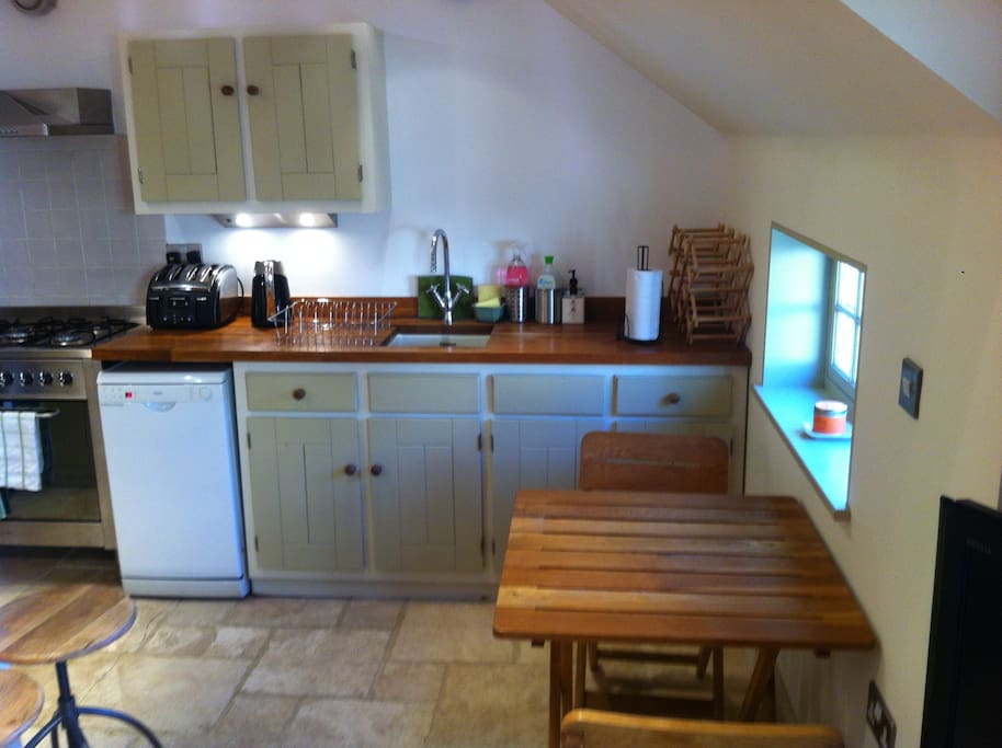 Kitchen with dishwasher, washing machine, fridge freezer and range cooker.