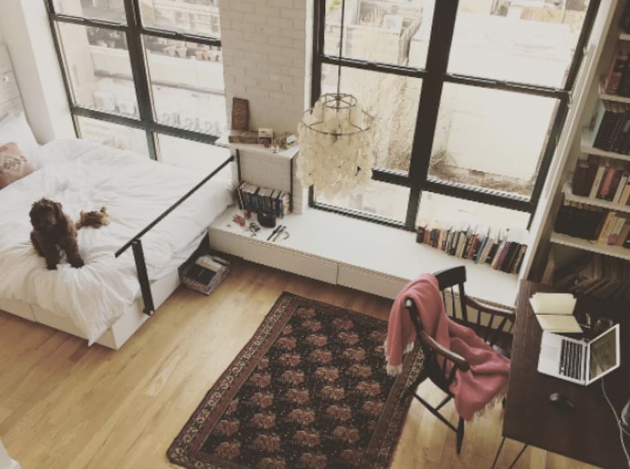 Looking down at our loft / bedroom from the stairs taking you to our private 900 sq ft roof!