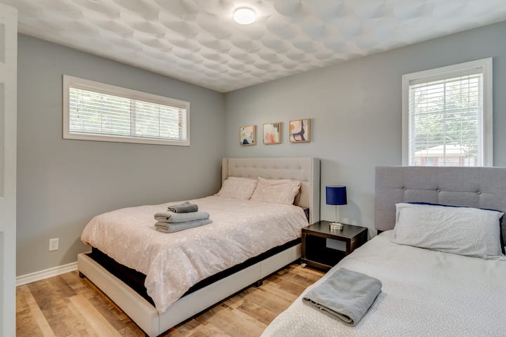 This inviting shared space features a plush queen bed and a comfortable single bed, perfect for families or friends