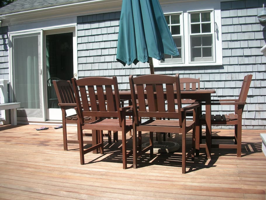 Back deck in early afternoon. Mahogany floor with surround built in benches.