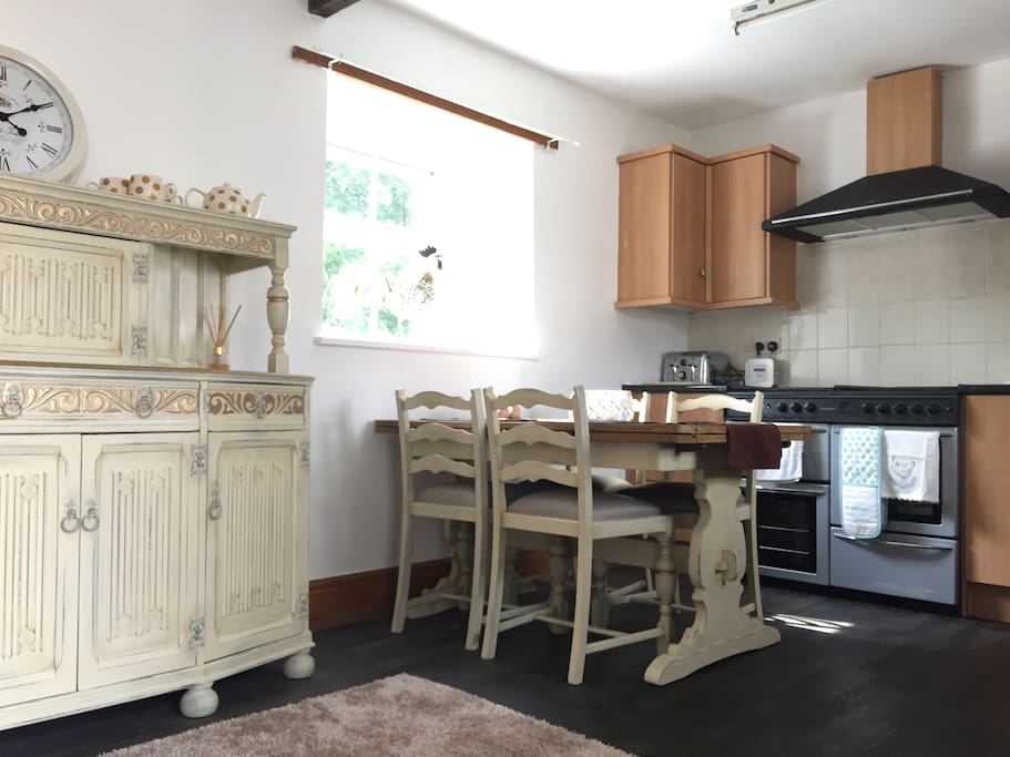 Kitchen with dining table. All essentials including washing machine and tumble dryer