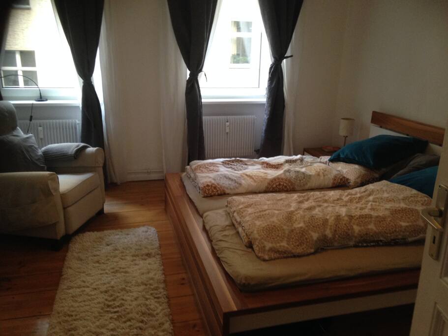 your room with king size bed and armchair