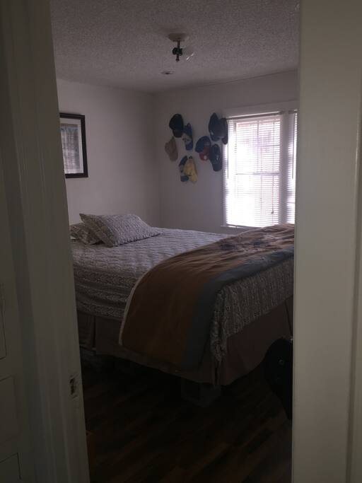 Bedroom A- Queen size bed, air conditioned room, closet with dresser draws, work-space and chair.
