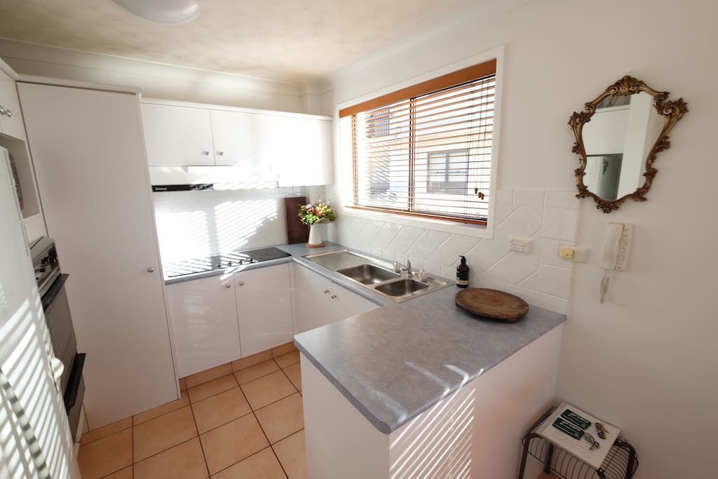 Full size kitchen with hot plates, oven, grill, fridge and freezer. Plenty of pots, pans and plates in storage.