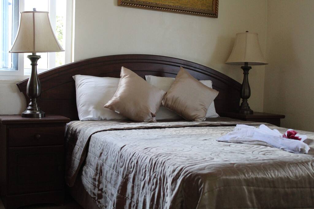 Comfortable queen sized bed in bedroom number two.