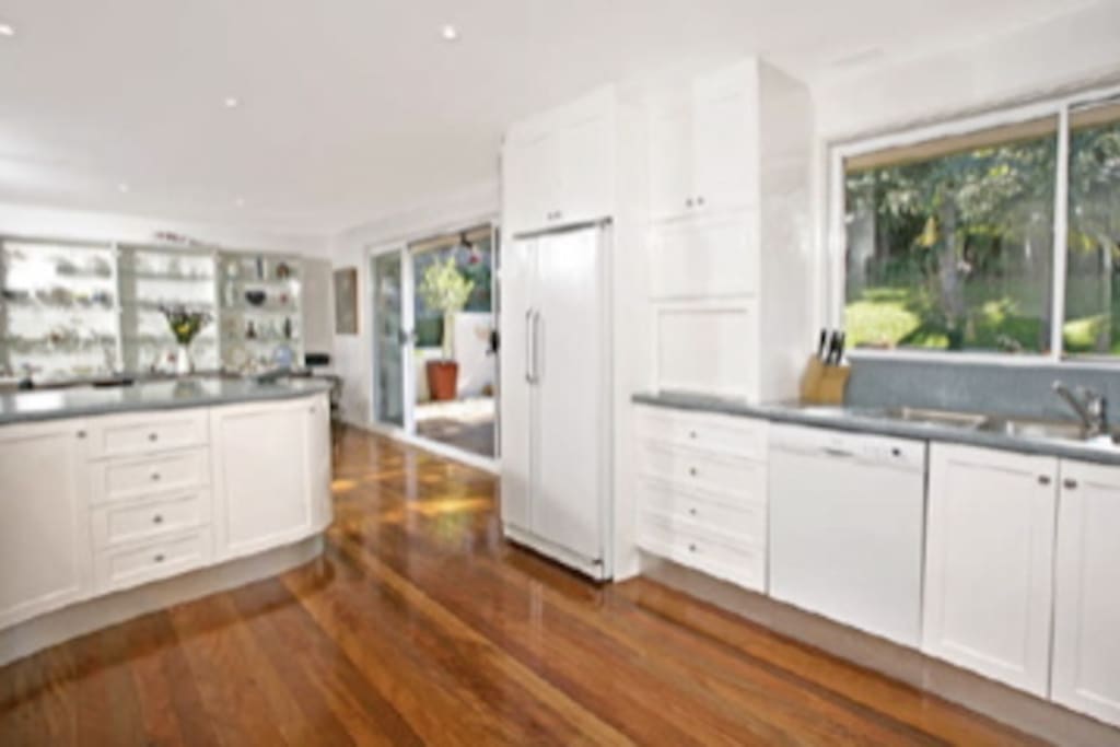 Spacious dining and kitchen areas with access to backyard deck.